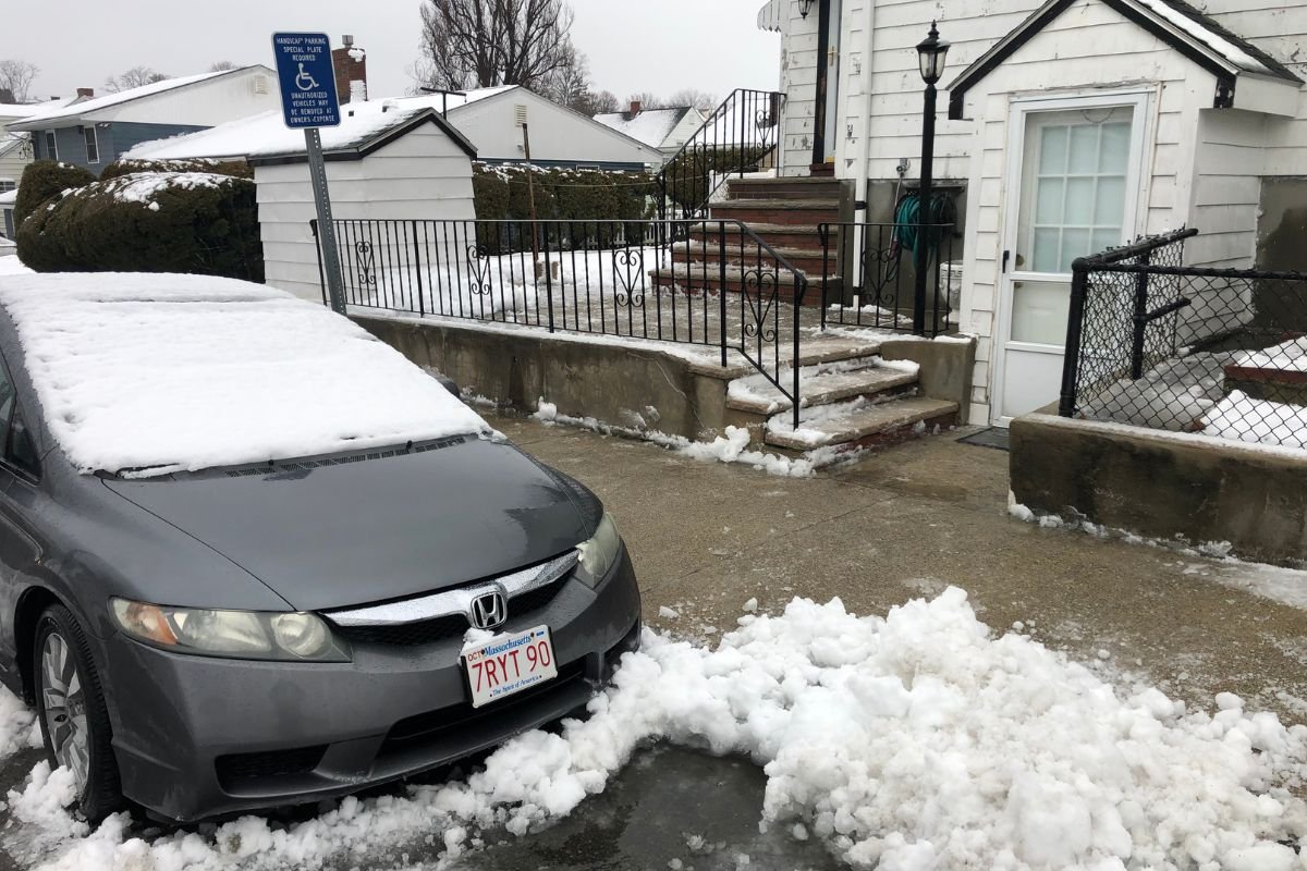 driveway-snow-clearing-residential-home Cleanly cleared residential parking space and front steps after professional snow removal