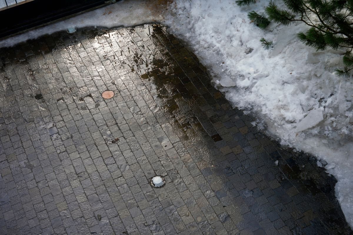 A cleanly cleared residential paver driveway and walkway maintained by Snow Removed