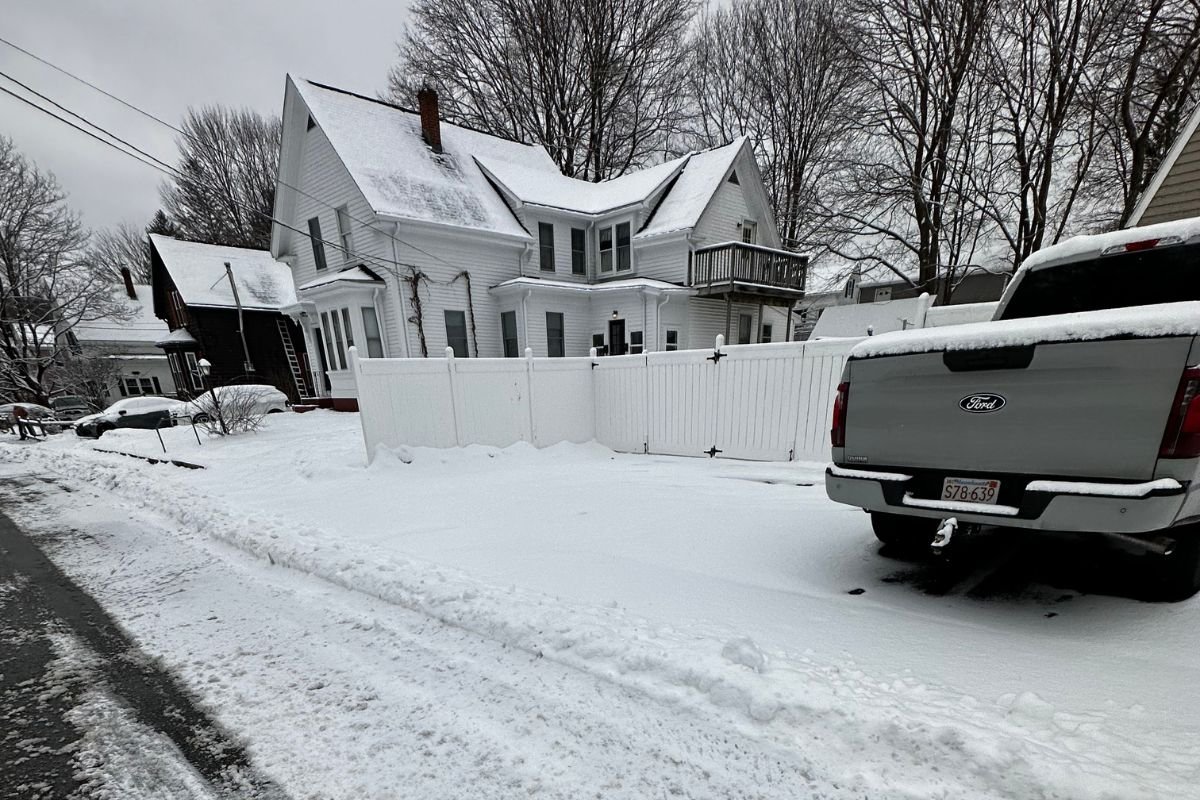 snow-removed-residential-house-driveway-cleared A typical residential neighborhood home with a professionally cleared snow driveway in Massachusetts